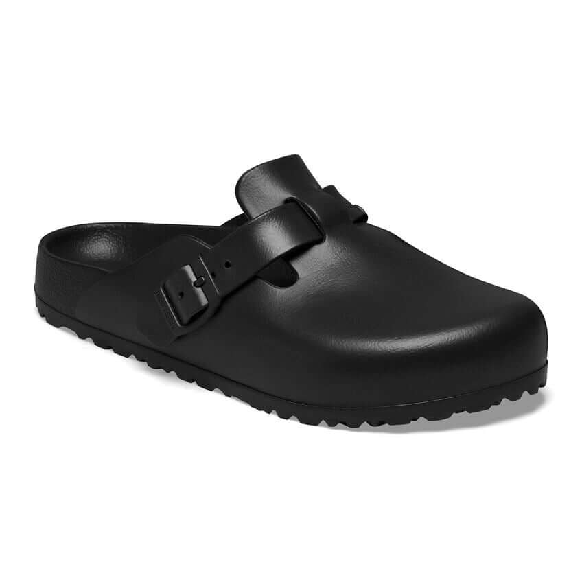 Black leather slip-on sandal with buckle detailing.