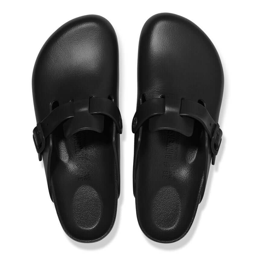 Black slip-on sandals with adjustable buckles and ergonomic footbeds