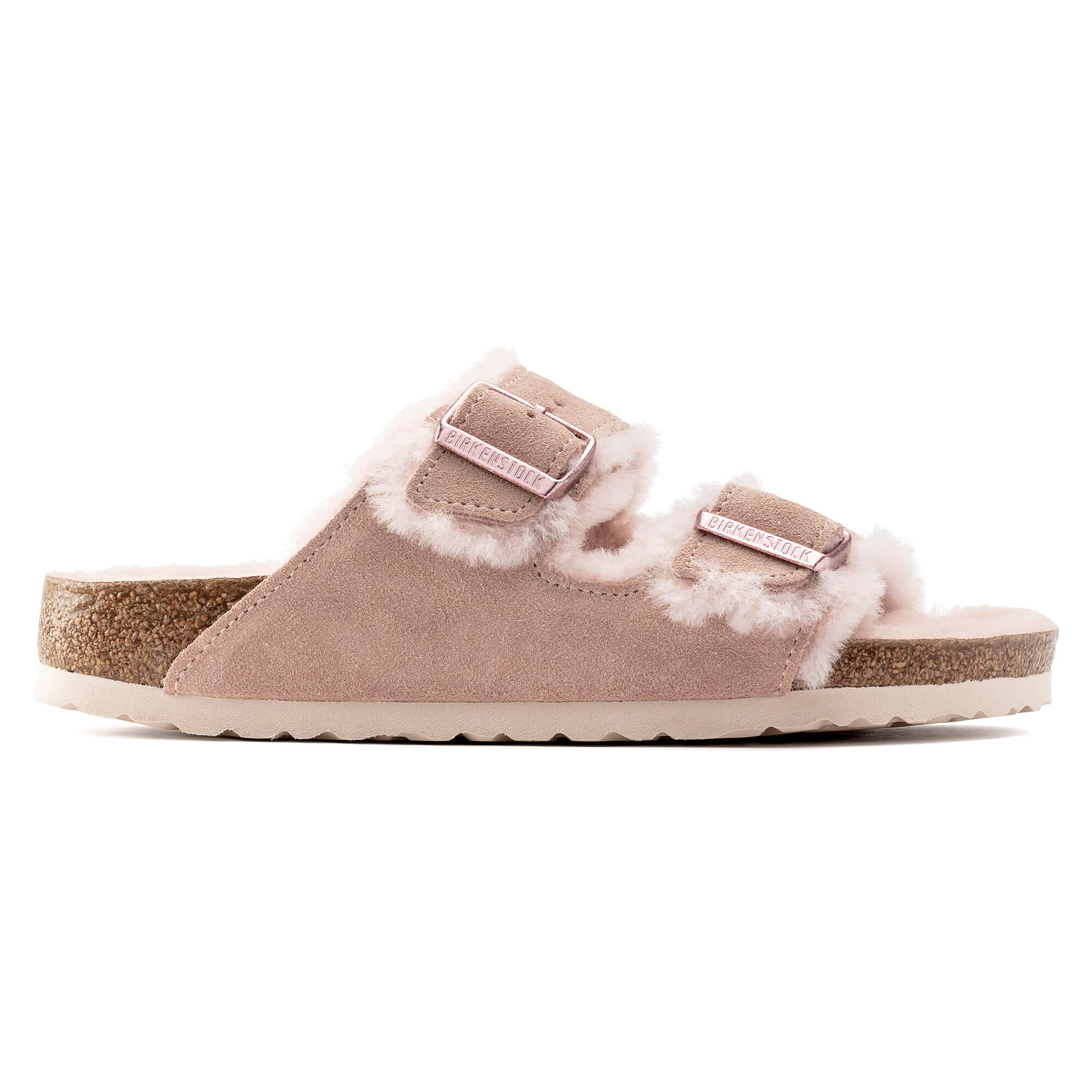 Pink suede slip-on sandal with fluffy shearling lining and buckle straps on cork sole.