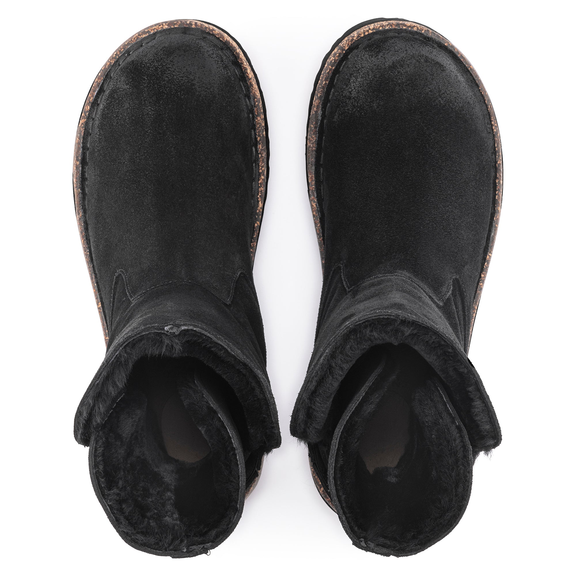 Top view of black leather winter boots with fur lining