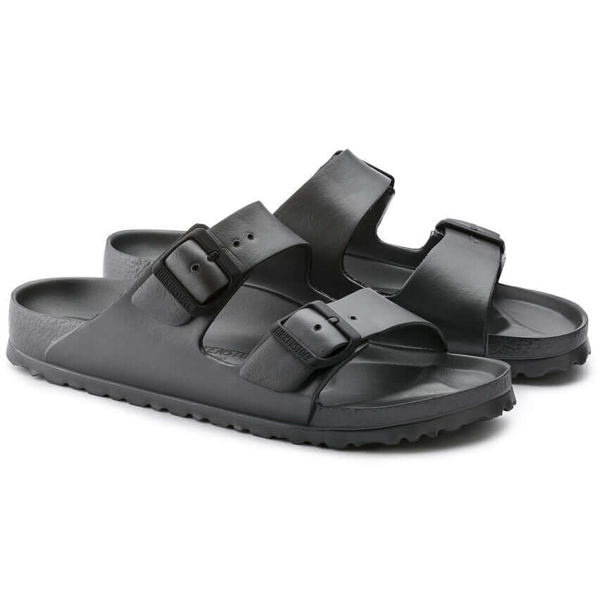 Black double-strap sandals with buckles on a white background