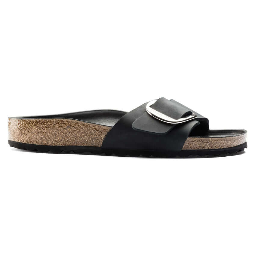 Black cork slide sandal with buckle detail and ergonomic footbed for comfort.
