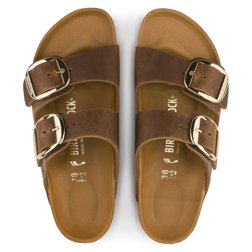 Top view of brown two-strap Birkenstock sandals with gold buckles