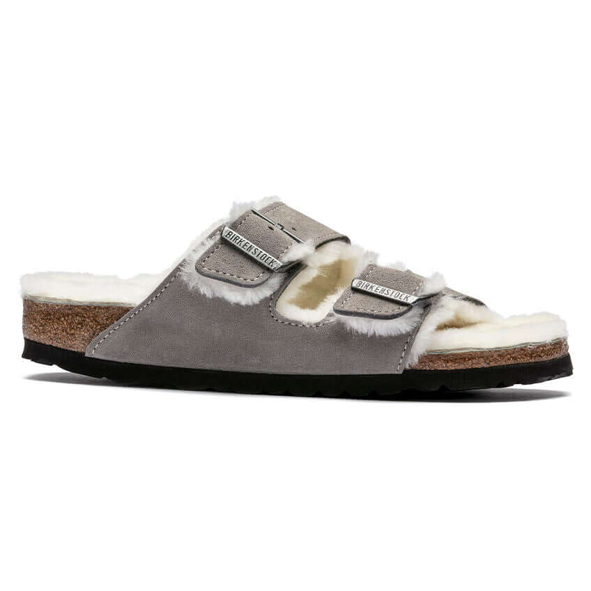 Grey sheepskin-lined Birkenstock sandal with cork sole and adjustable straps