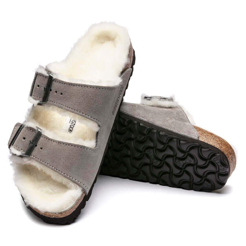 Comfortable grey sandals with fur lining and adjustable straps on a white background