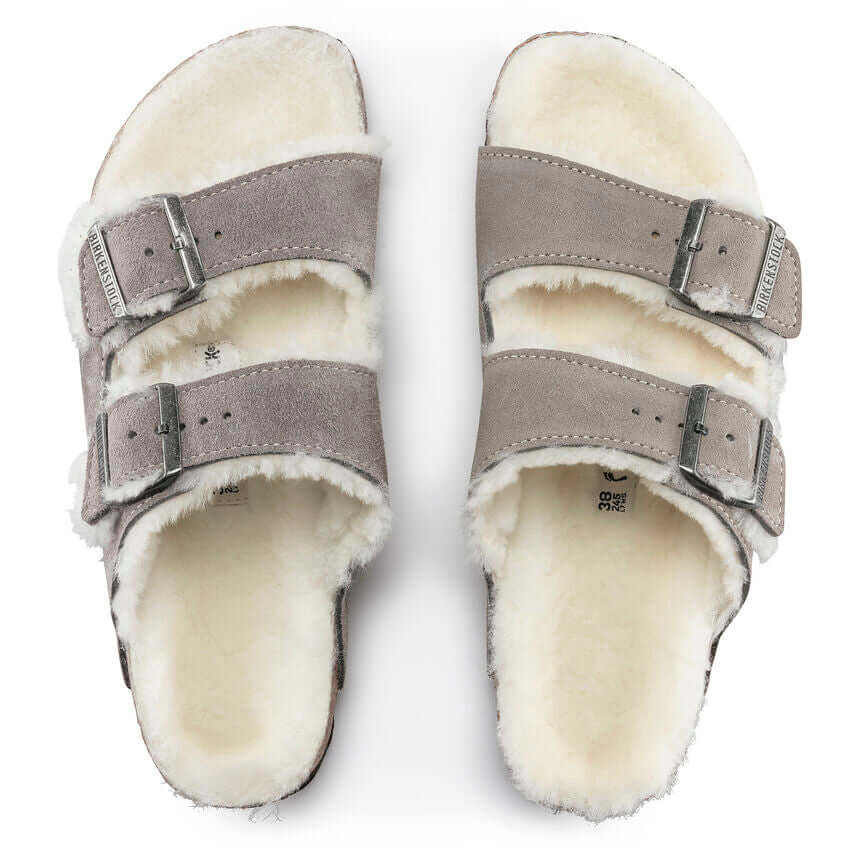 Comfortable grey suede sandals with fur lining and adjustable double buckle straps, providing warmth and style.