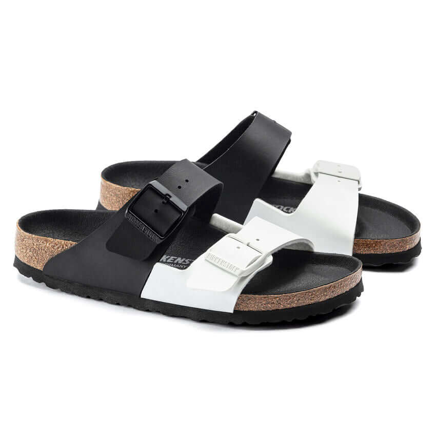 Black and white sandals with cork soles and adjustable straps