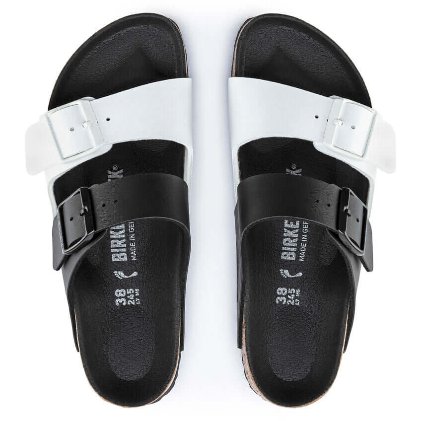 Birkenstock black and white double-strap sandals, viewed from above, featuring adjustable buckles and a comfortable footbed design