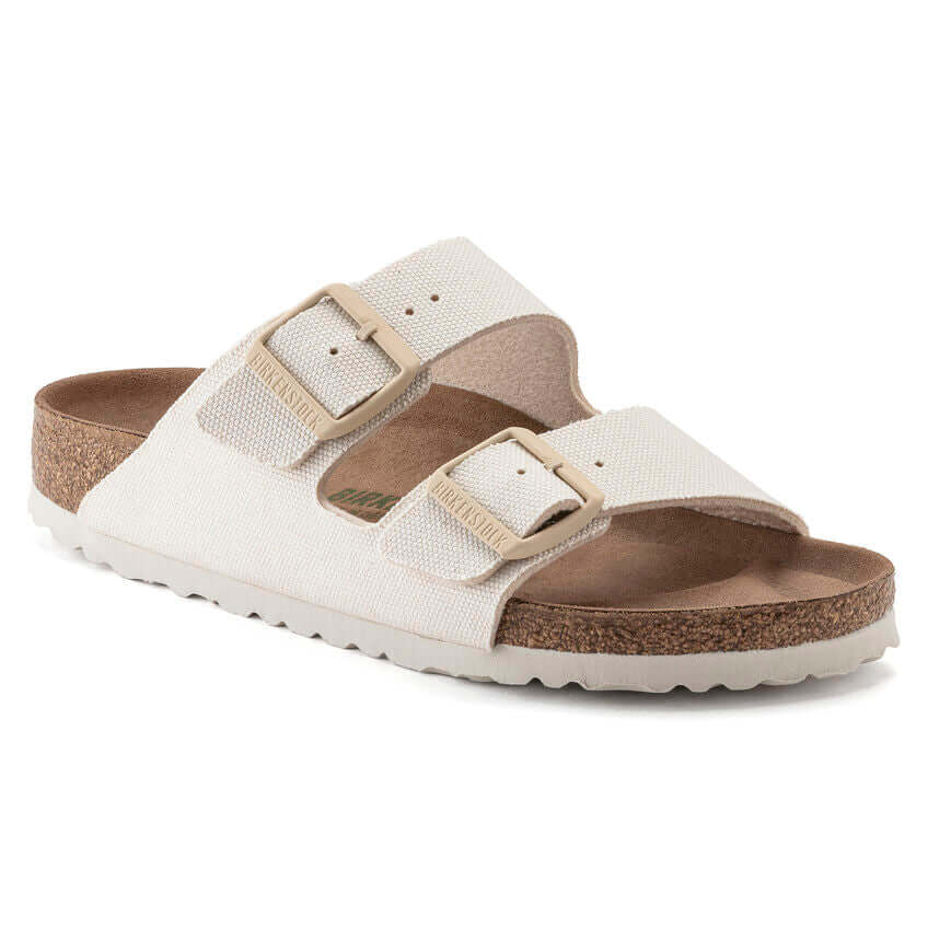 White Birkenstock Arizona sandals with double adjustable buckles and cork footbed
