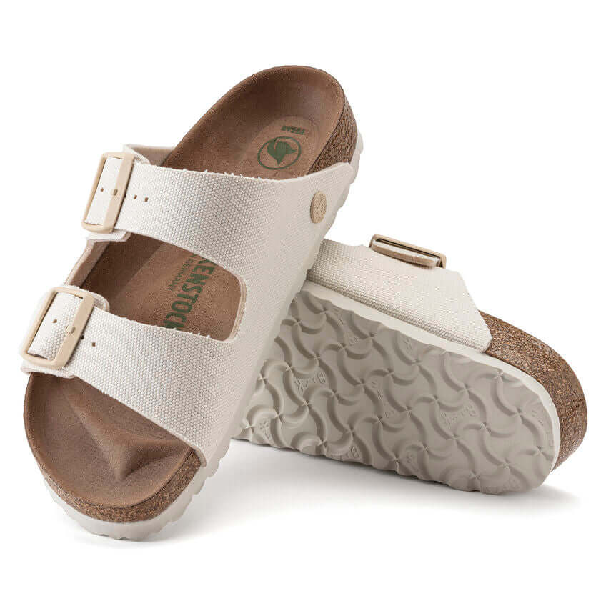White Birkenstock Arizona sandals with cork footbed and molded sole.