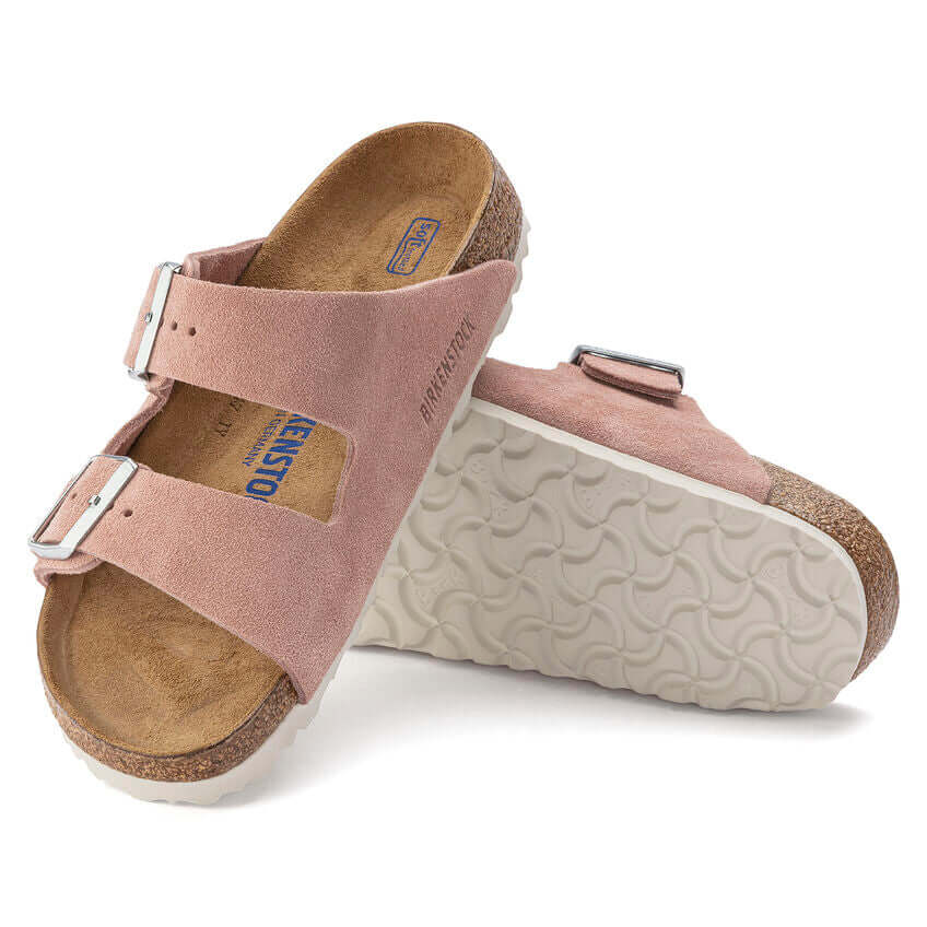 Stylish pink suede Birkenstock sandals with adjustable straps and white soles.
