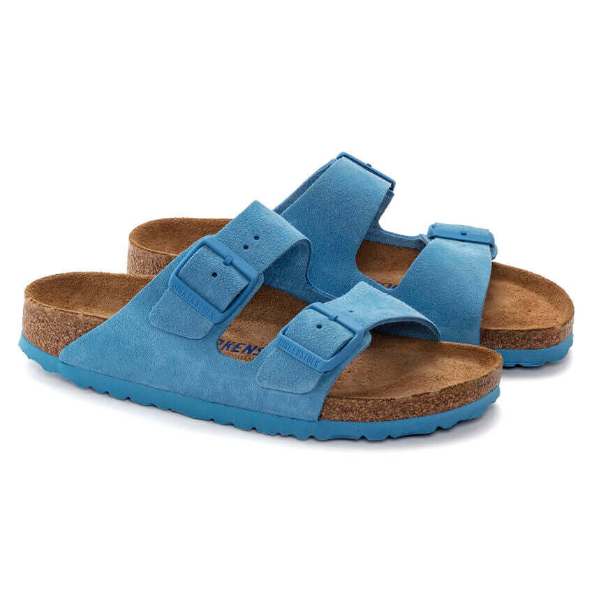 Blue suede Birkenstock sandals with double strap and cork sole.