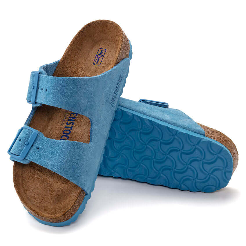 Blue Birkenstock sandals with cork sole and double buckle straps on white background
