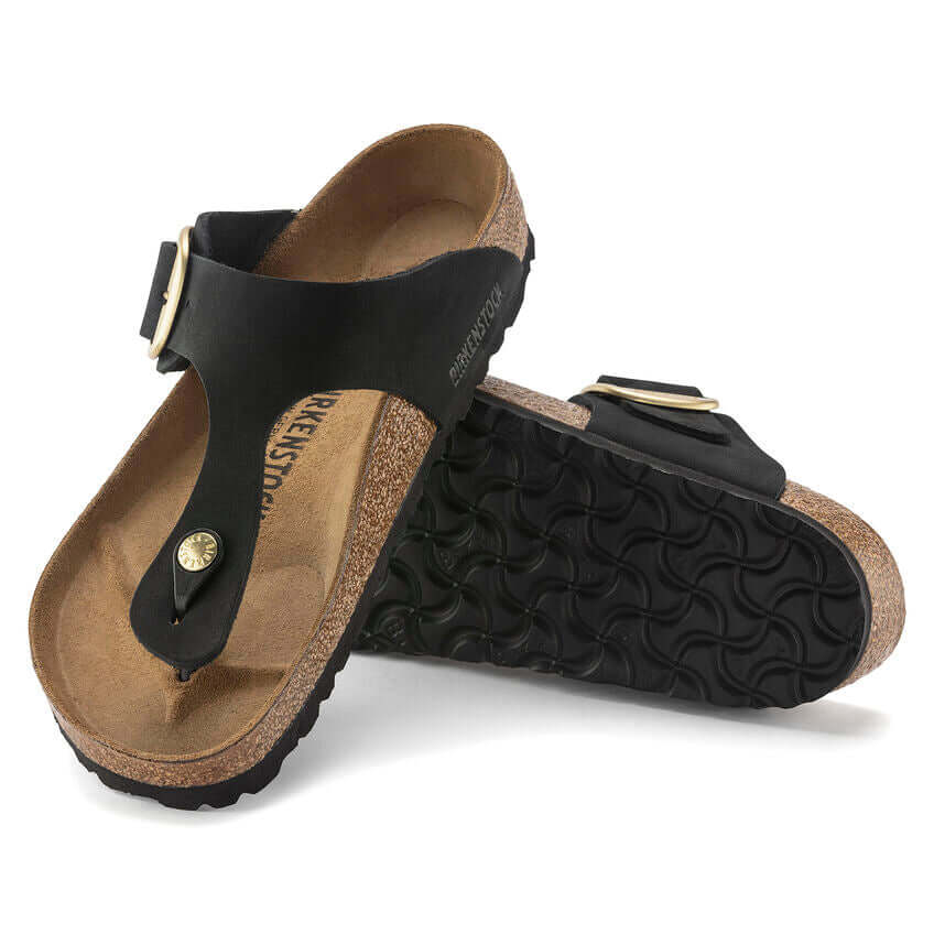 Black leather Birkenstock sandals with cork sole and buckle strap