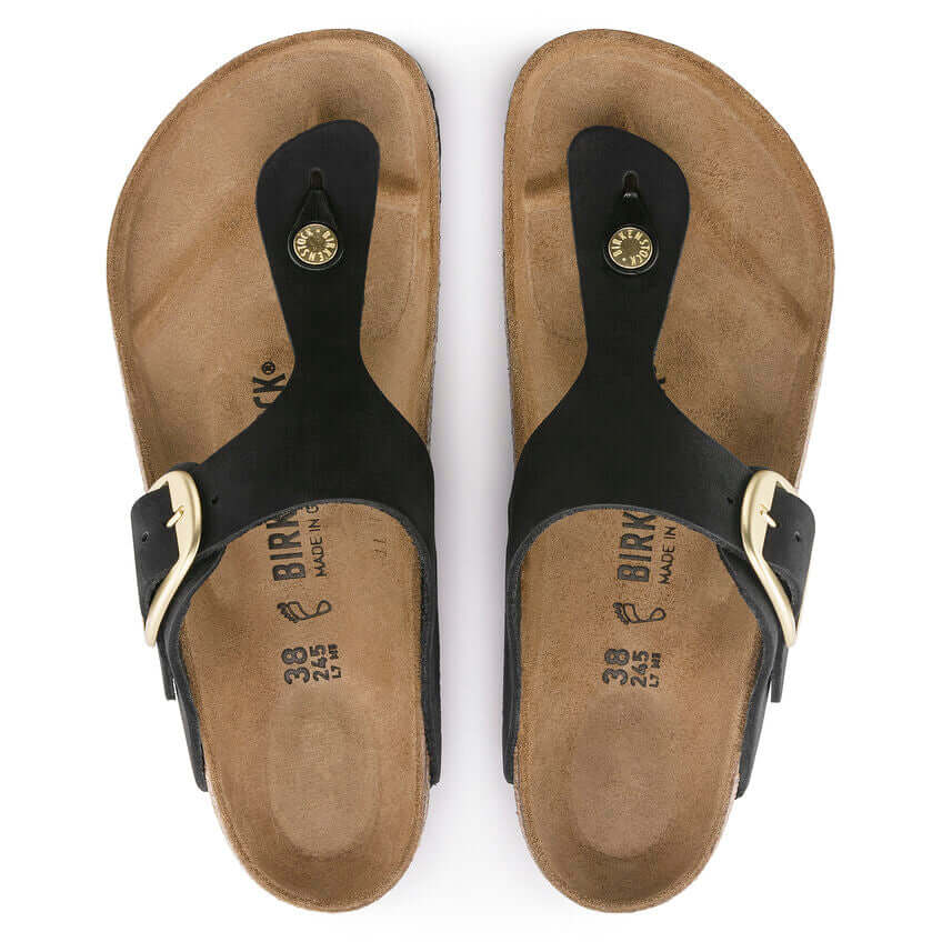 Black Birkenstock sandals with brown cork footbed and adjustable straps